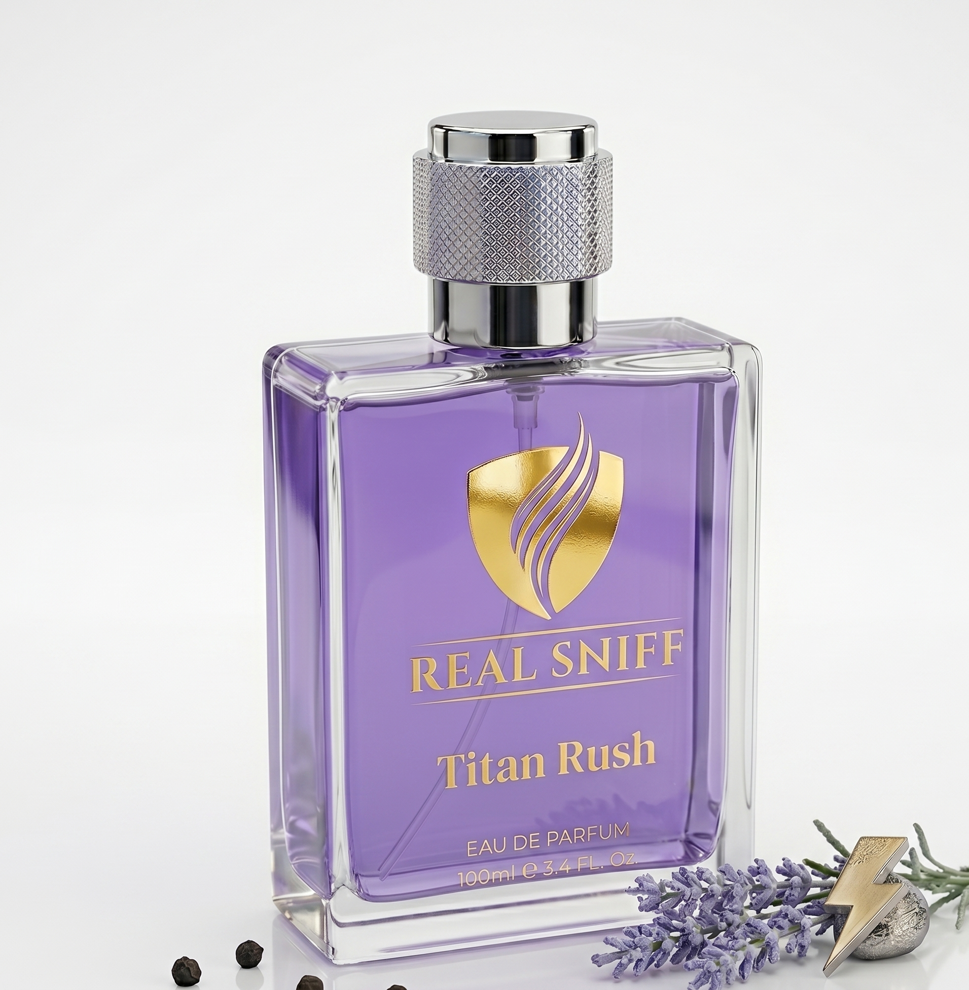A visually engaging close-up of the Real Sniff Titan Rush 100ml perfume bottle, focused on the golden label and textured silver cap. The scene highlights the ingredients that define the scent: scattered dark peppercorns for fresh spice and vibrant sprigs of true lavender, emphasizing the cool, aromatic nature of the fragrance.